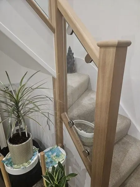 First-floor landing with oak handrail and glass balustrade panels